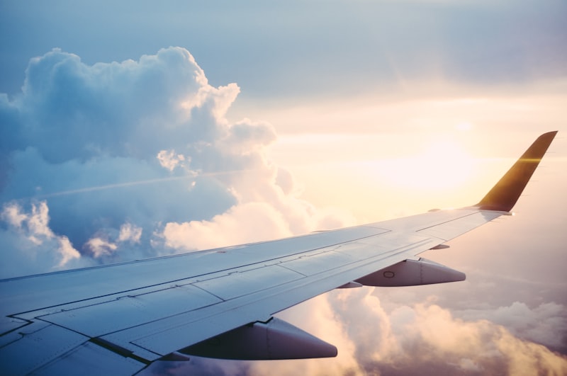 A premium passenger jet flying above the clouds